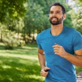 Handsome,Man,Running,In,Park,With,Earphones