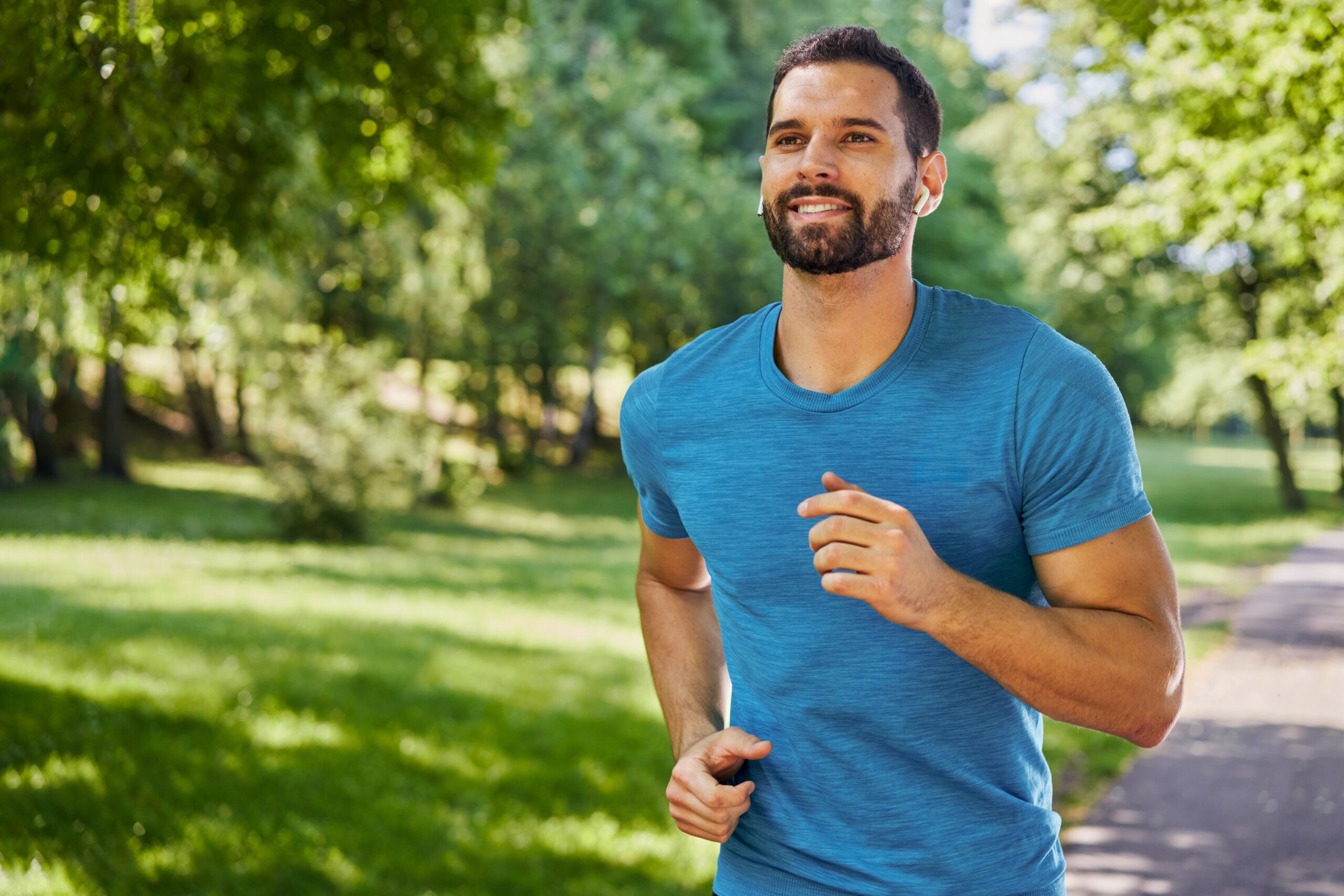 Handsome,Man,Running,In,Park,With,Earphones