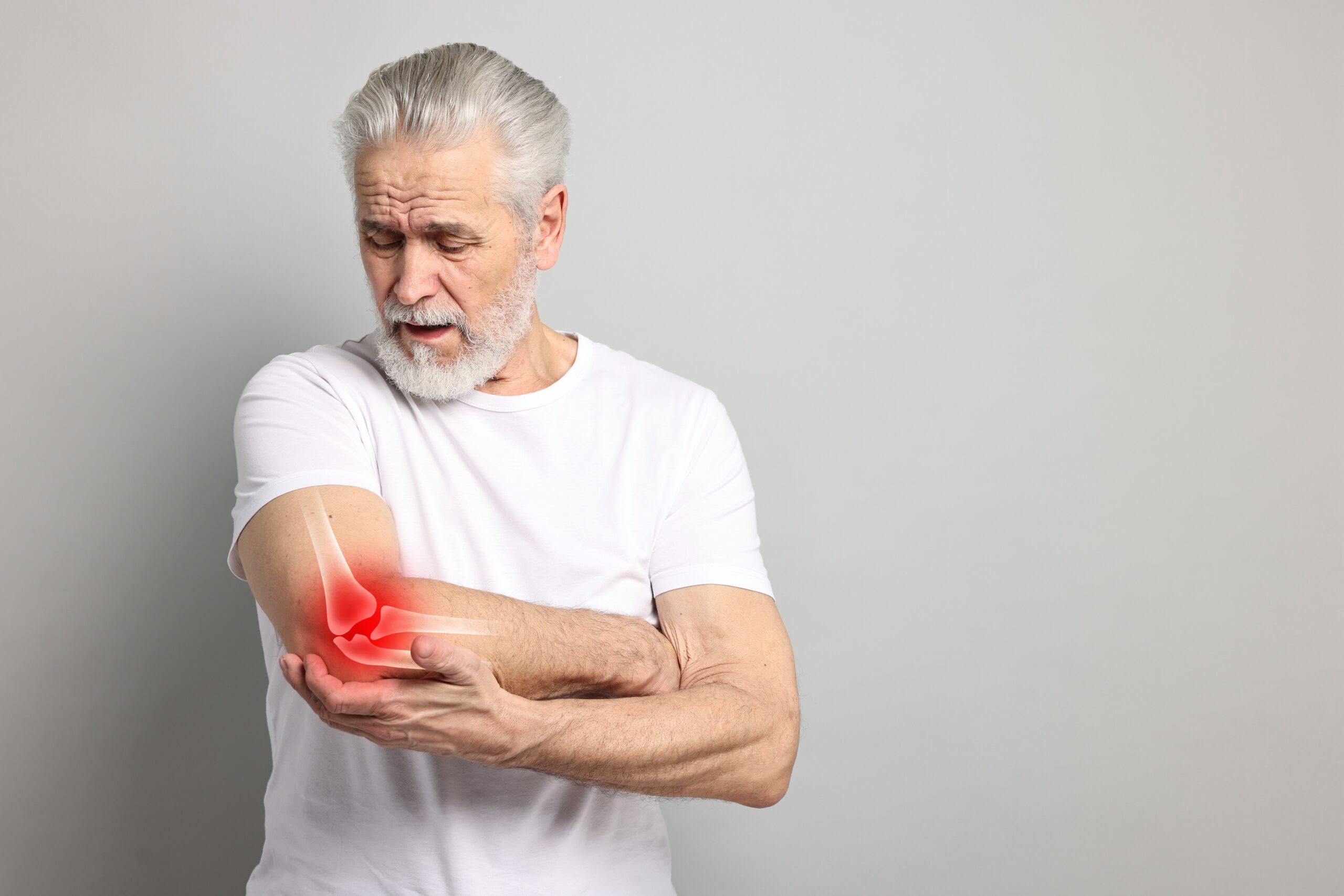 Arthritis.,Senior,Man,Suffering,From,Pain,In,Elbow,On,Grey