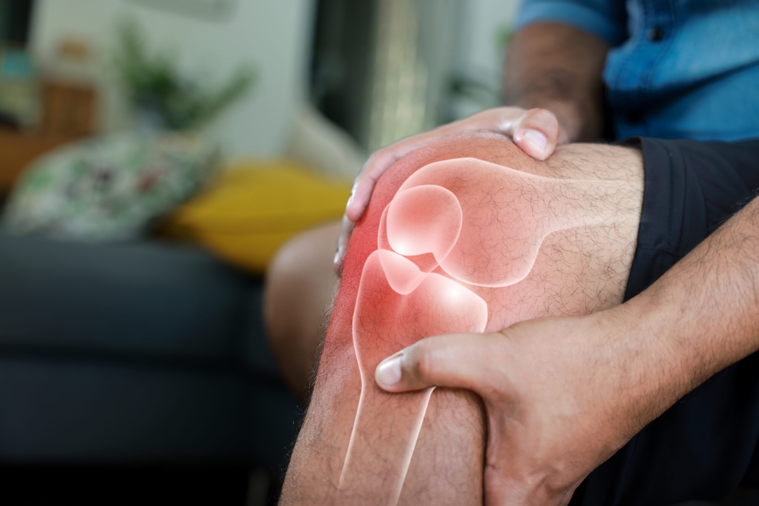 Close-up,Of,Hand,Holding,Painful,Injured,Knee,With,Red,Inflamed