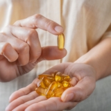 The,Woman,Holds,Omega-3,Capsules,In,Her,Hand